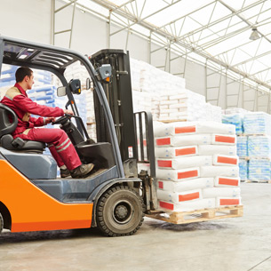 Forklift driver stacking pallets